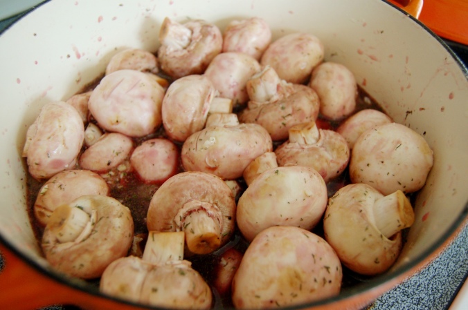 Throw mushrooms into the pot and stir to get covered with ingredients. It will look like a lot but they will reduce quickly. 